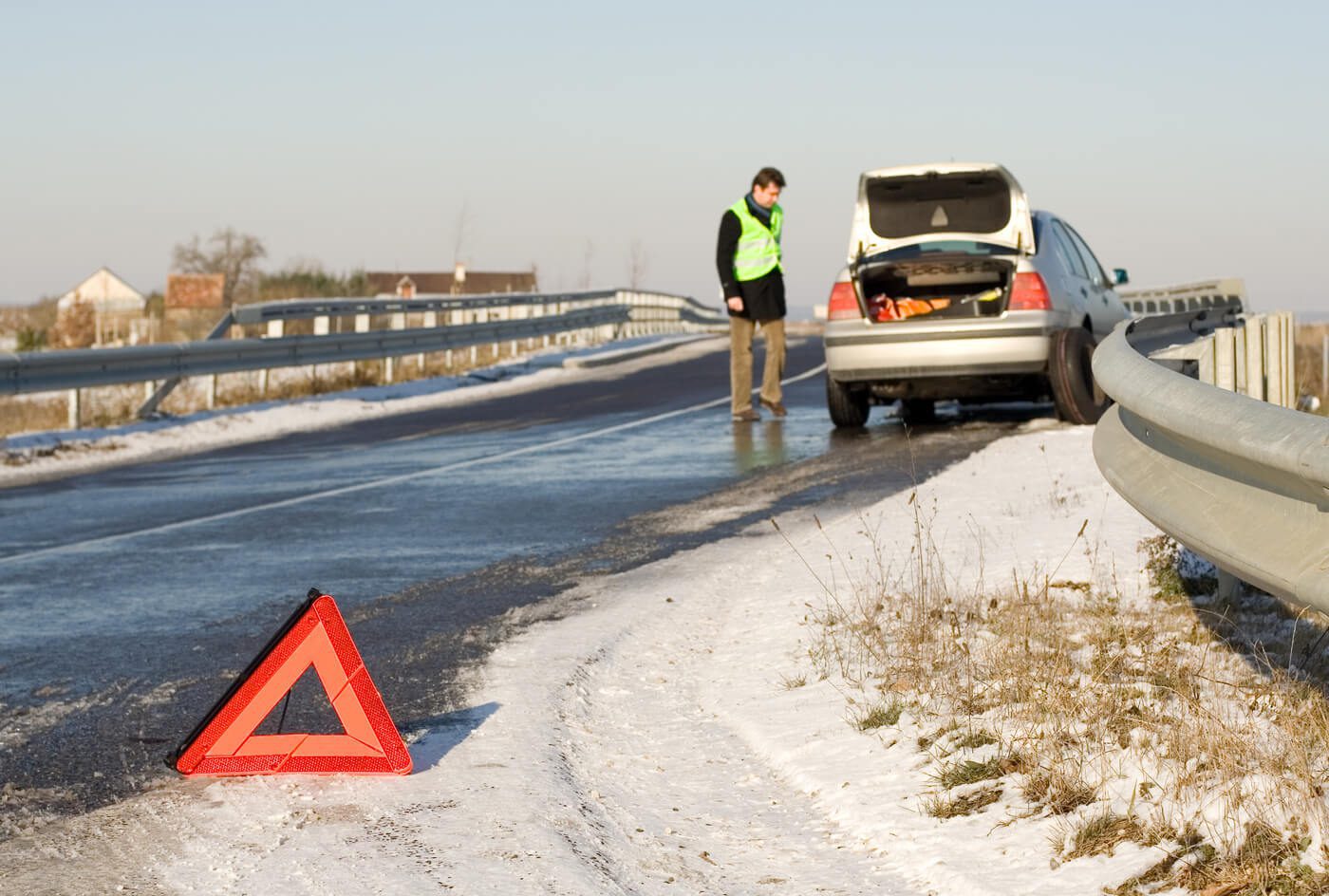 Warning triangle on winter road