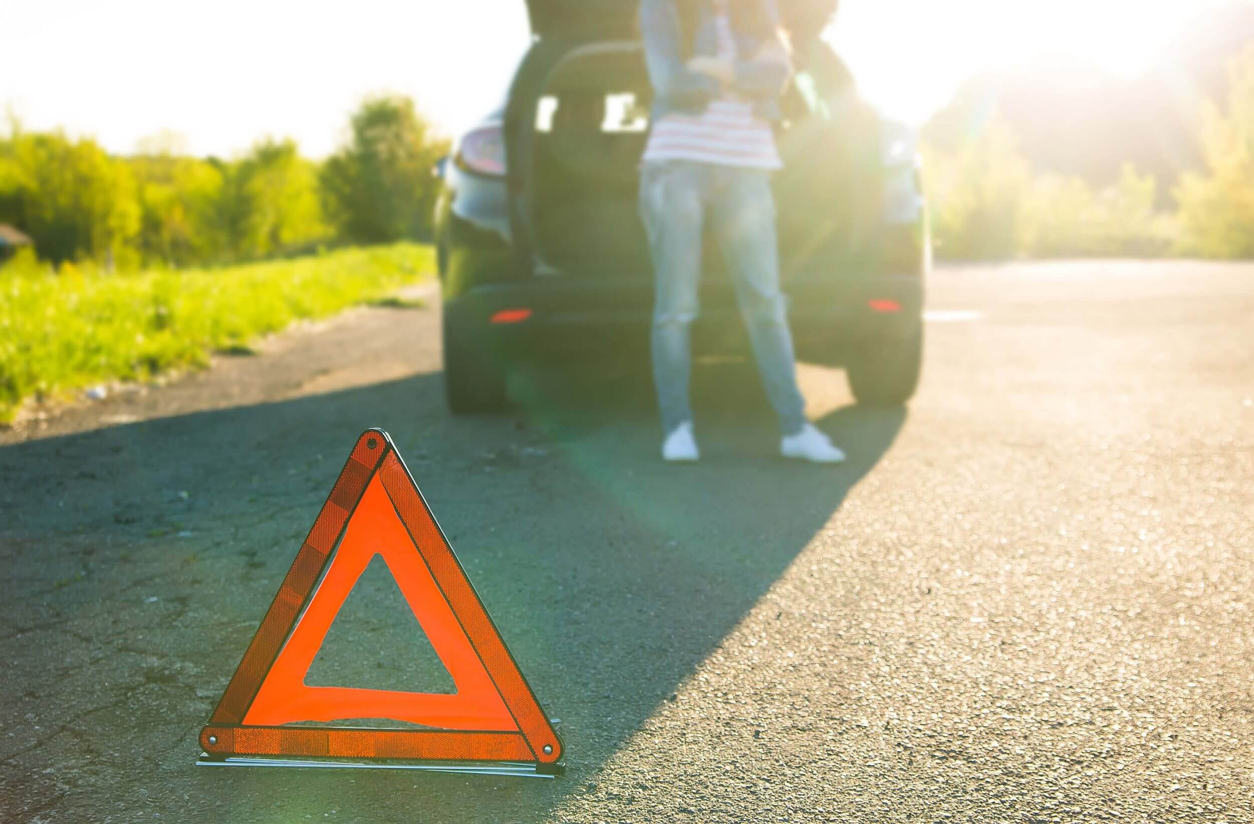 Warning triangle by brokendown car