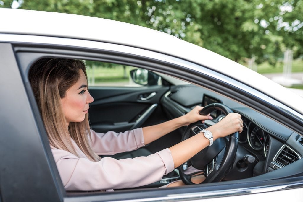 Woman driving car on right handside