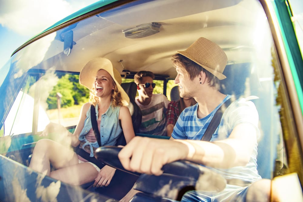group of young adults driving to a music festival