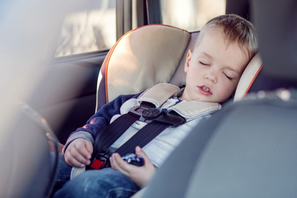 Child fast asleep in car