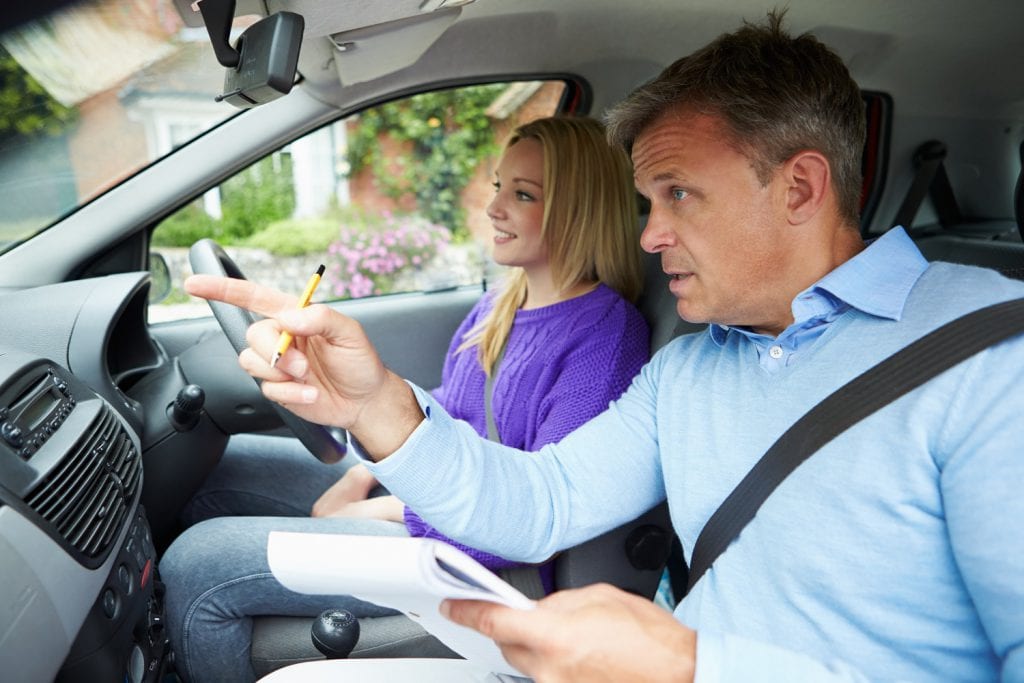 Driving instructor teaching student