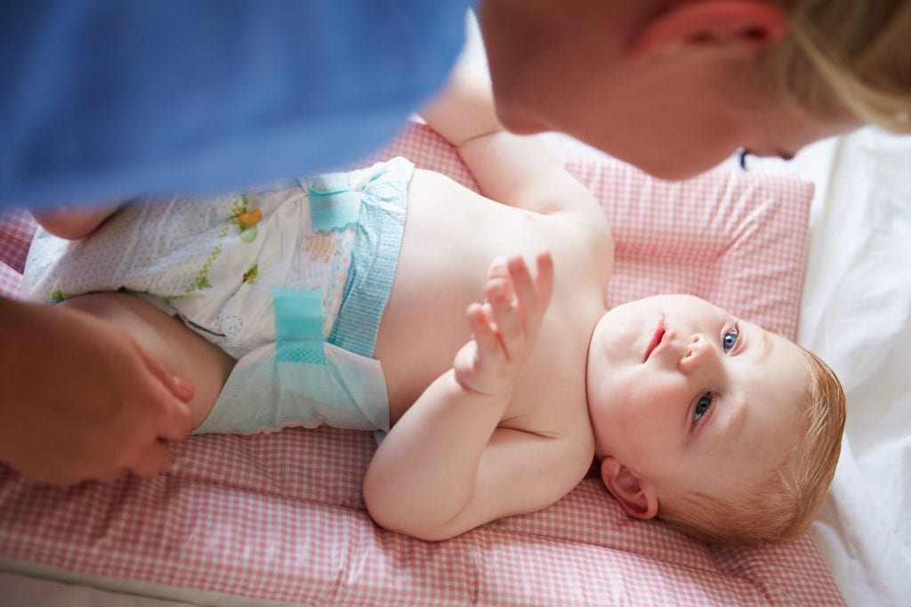 Parent changing baby's nappy