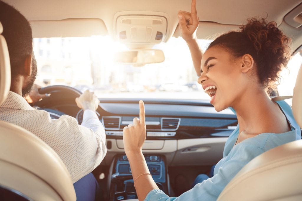 Couple singing to music in the car