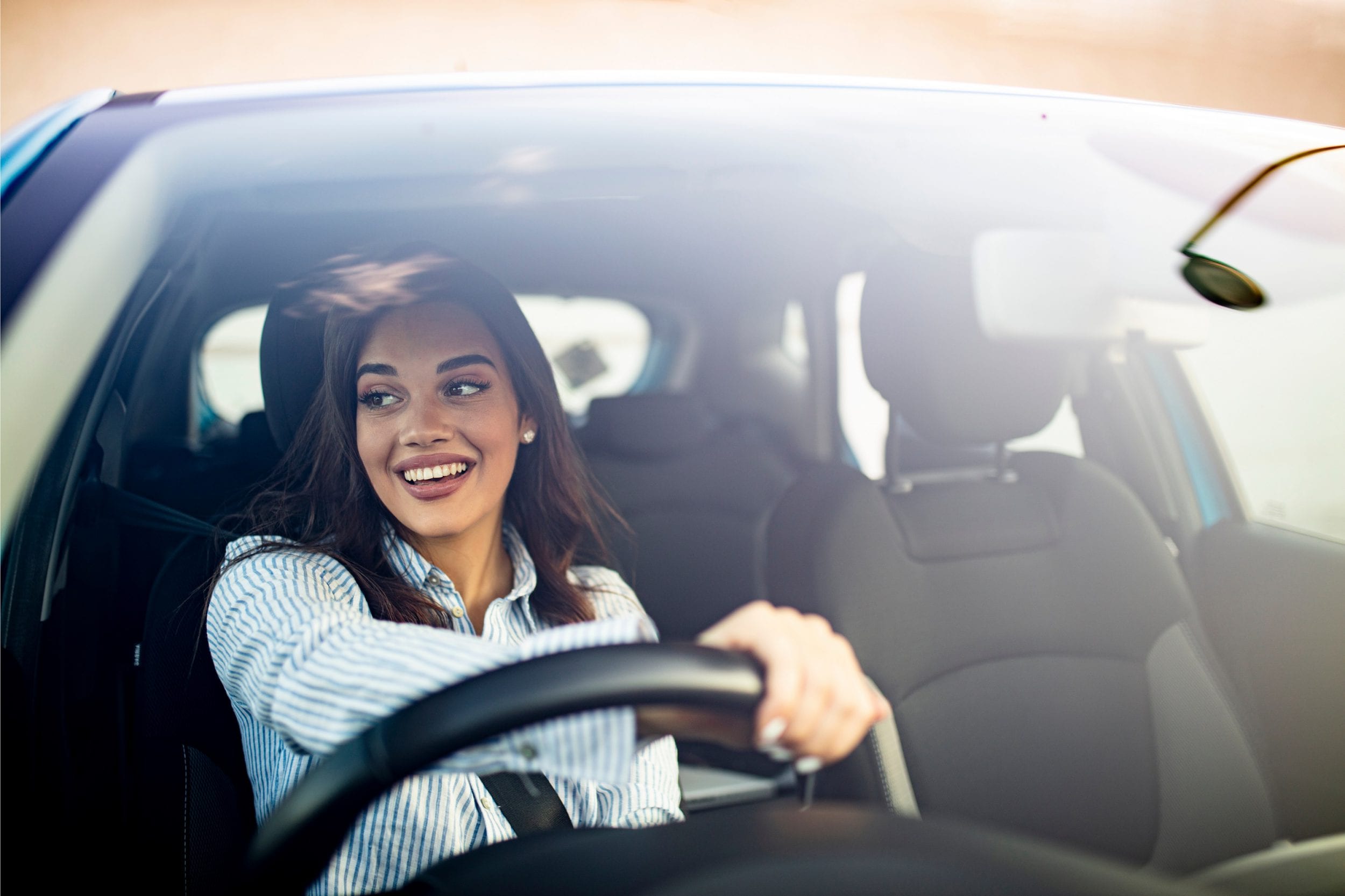 Woman driving a car happy