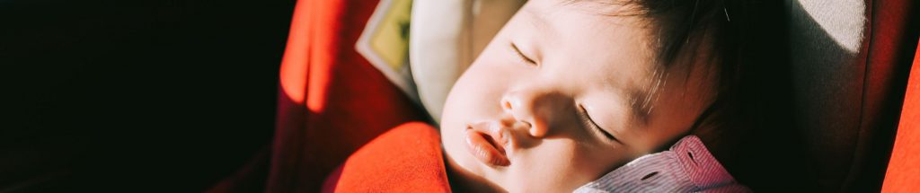 Young child asleep in car seat