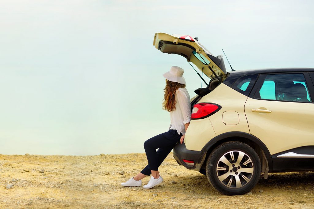 image of person sat in the boot of a car