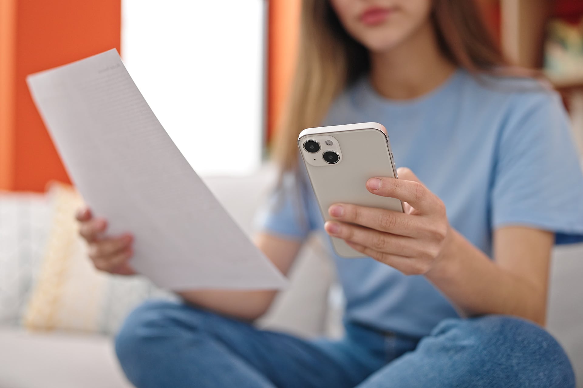image of girl holding mobile and document