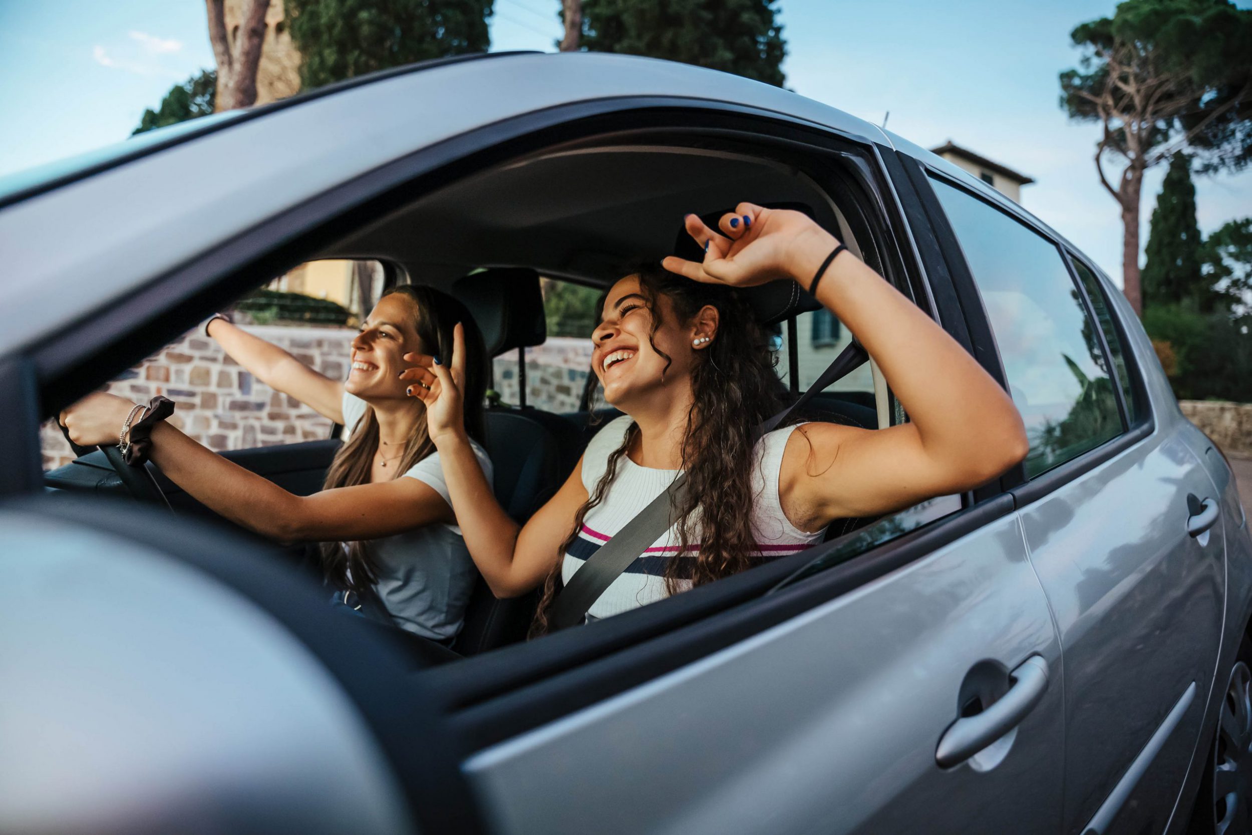 Two young women sing a song on the radio