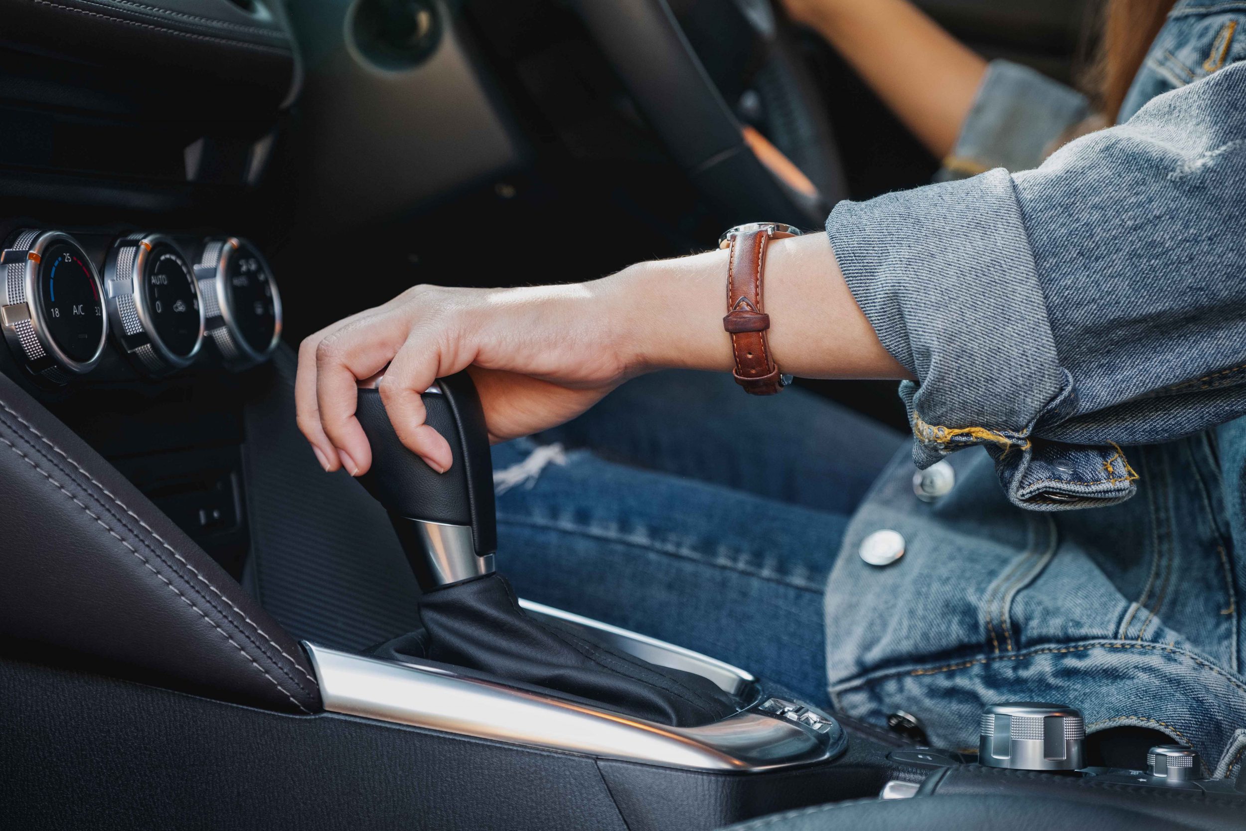 female driver shifting automatic gear stick