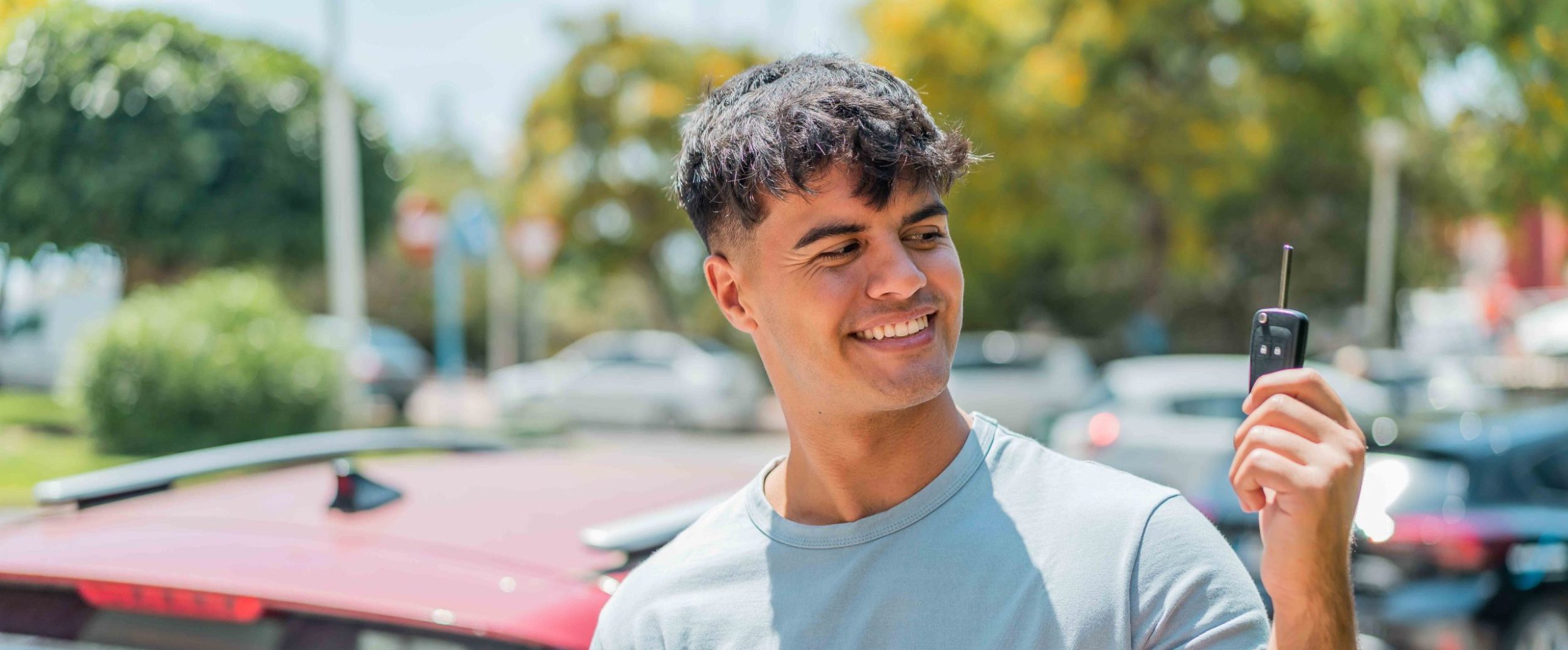 Young driver with car key